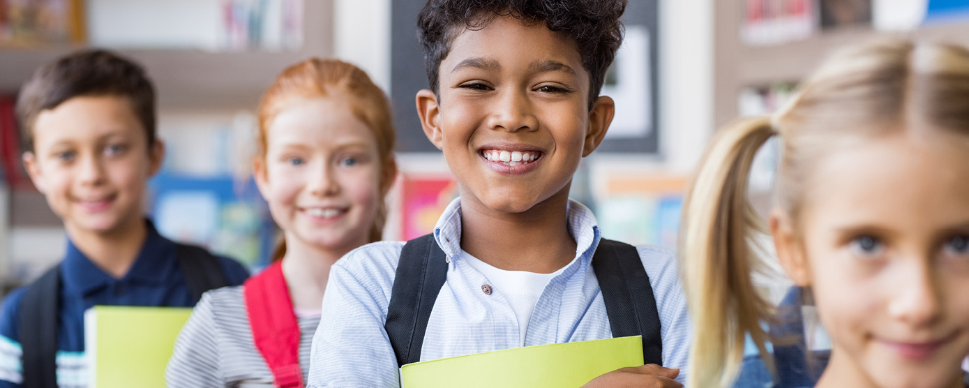 elementary students smiling in school line