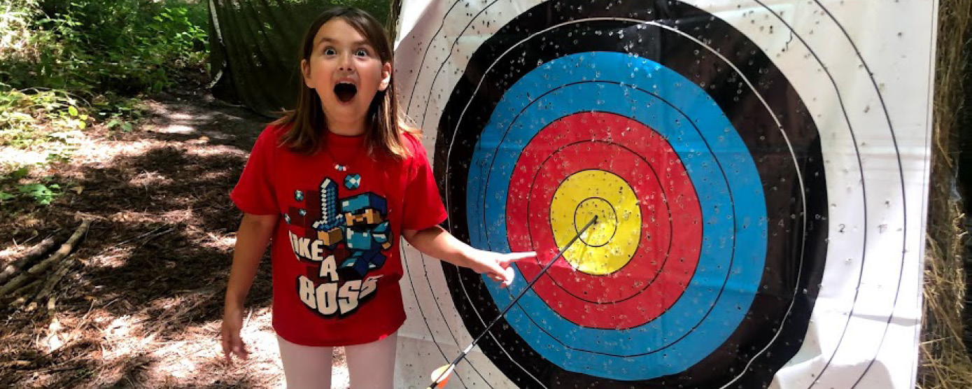 happy camper with their archery bullseye