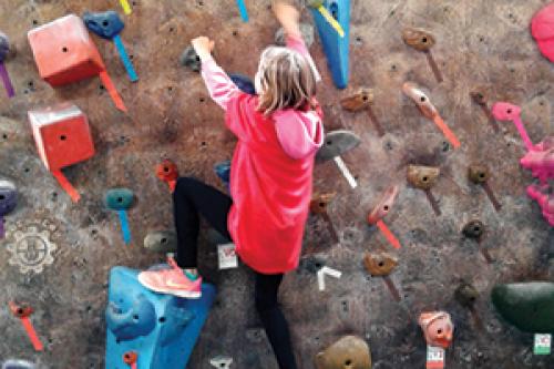 Girl on rock wall