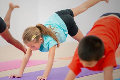 Three kids exercising in fitness class