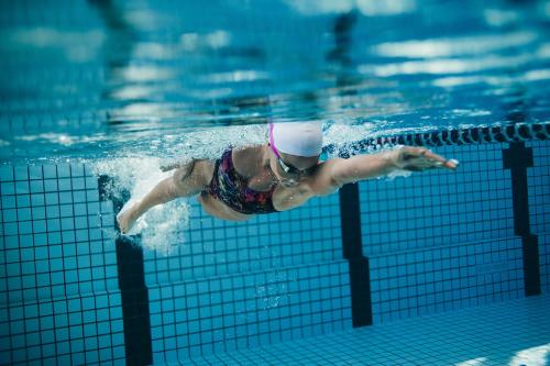 cool underwater shot of woman swimming laps