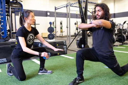 coach giving lunge instructions to participant