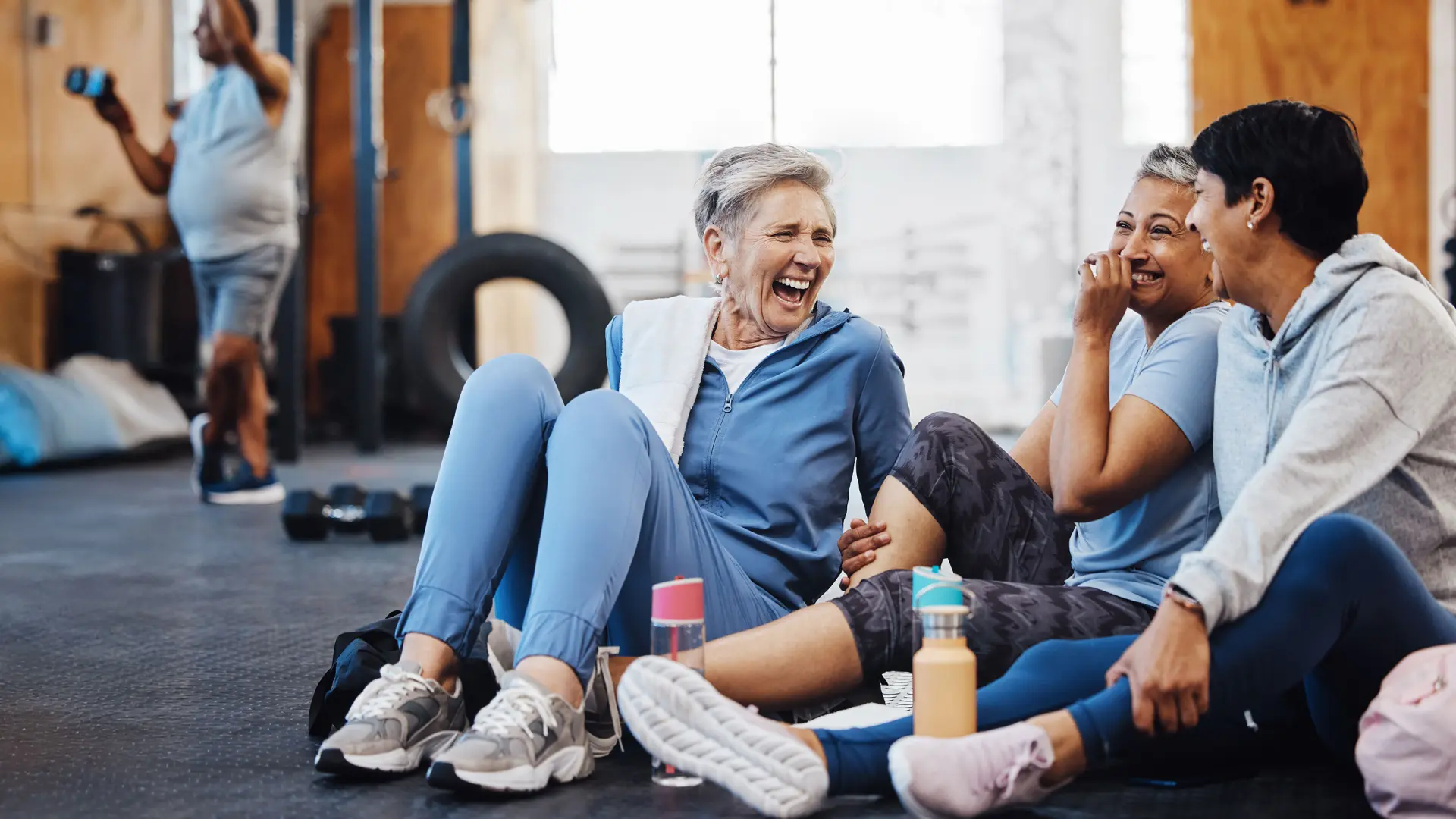 Seniors in a group post work chatting and laughing 