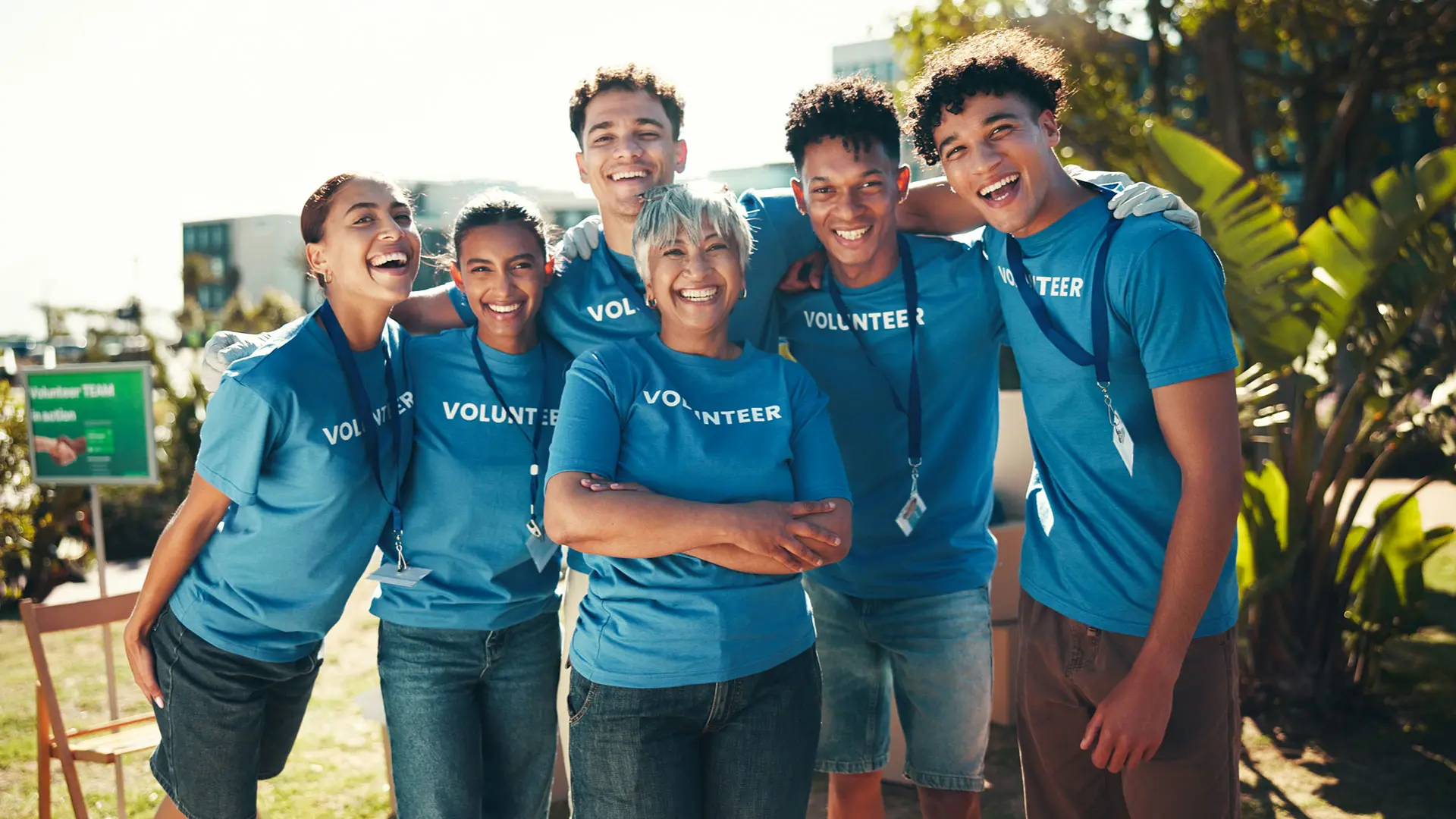 Team of volunteers smiling at an outdoor event