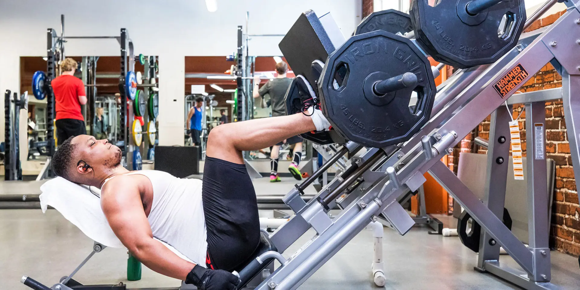 Berkeley YMCA member doing leg weight lifts on machine