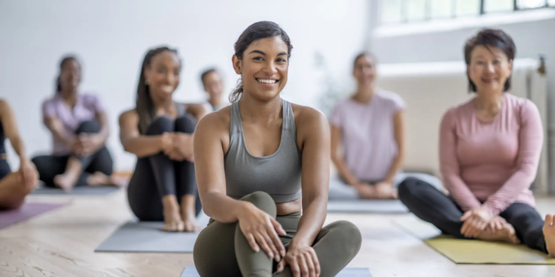 Yoga Class with group of diverse women sitting on mats