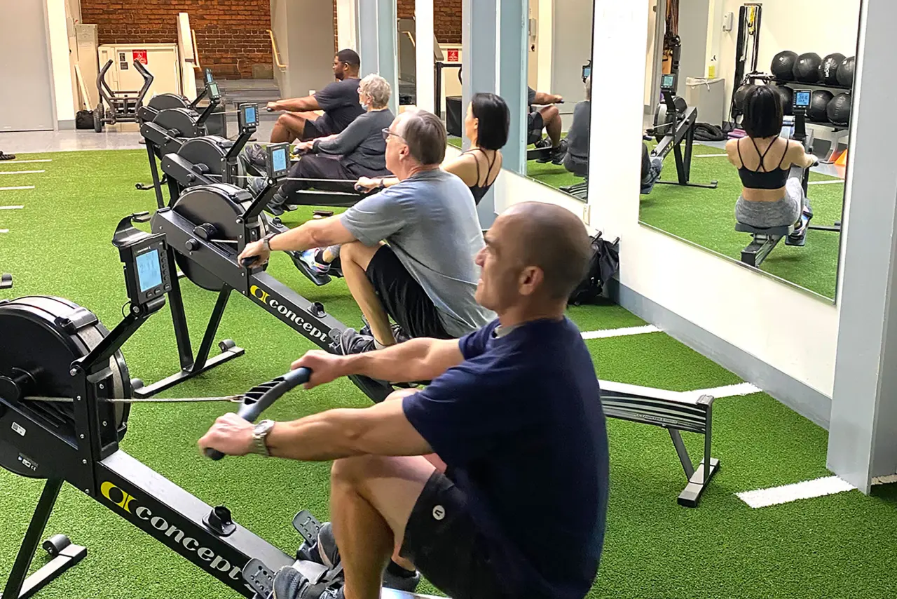 Berkeley members taking a Rowfit group exercise class in the fucntional fitness area