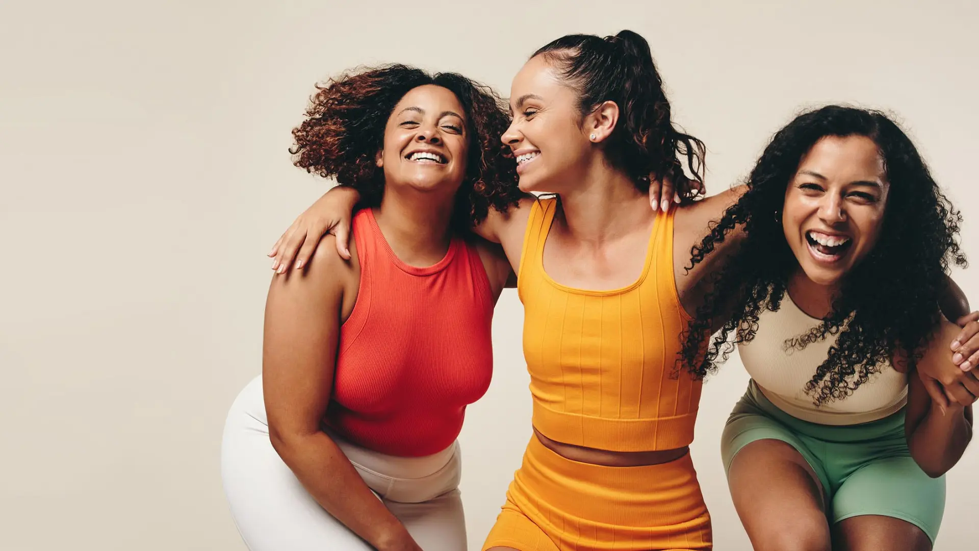 Adult female member trio in fitness clothing laughing
