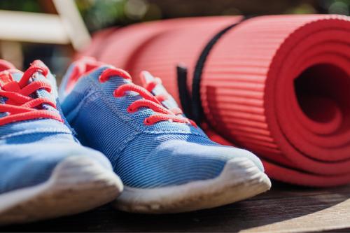 shoes and yoga mat on the ground