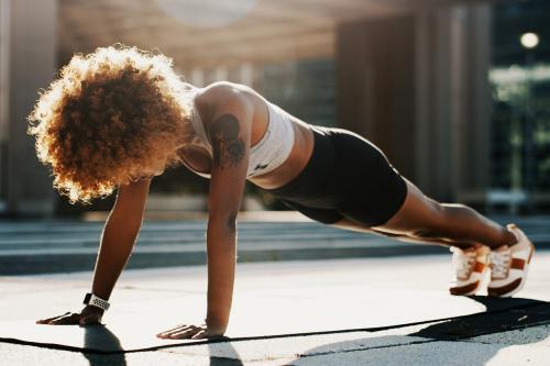 woman outside doing a very impressive plank