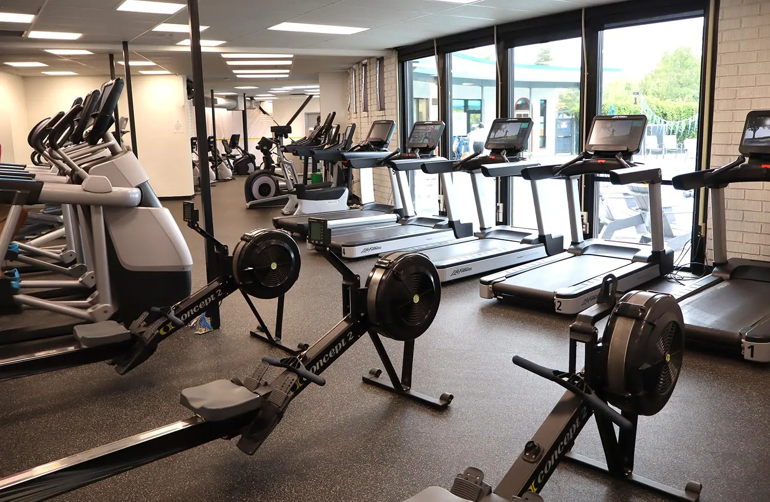 Pleasant Hill cardio area overlooking outdoor pool