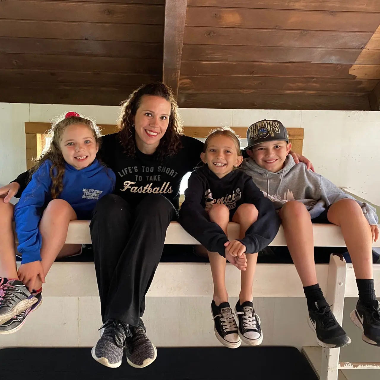 mother with three children sitting on top bunk bed at Camp Loma Mar