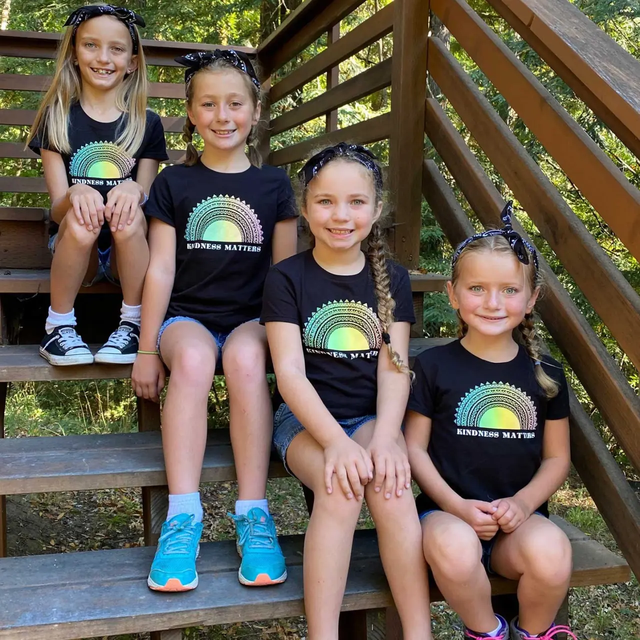 group of Camp Loma Mar girl campers on steps of cabin during a family camp session