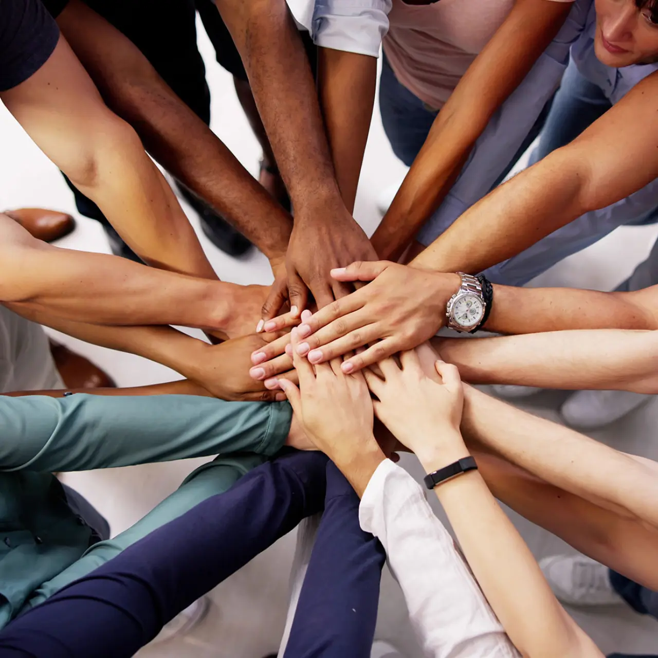 Group of diverse people with all hands in 