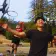 Two boys play basketball, one of them runs away from the basket with his arms outstretched while his friend flies through the air to dunk the ball behind him, recreating an iconic picture of Lebron James and Dwyane Wade on the Miami Heat.