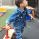 Toddler female student playing with mini scooter style bicycle