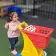 Early Learning Center female toddler playing with a toy shopping cart on outdoor playground