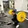 Young adult woman lifting barbell in weights area of the Oakland YMCA
