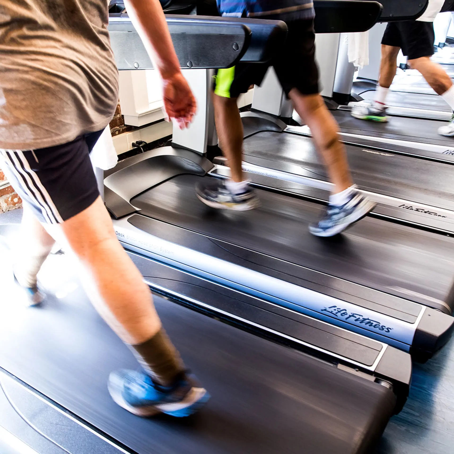 Members legs walking quickly on cardio machines