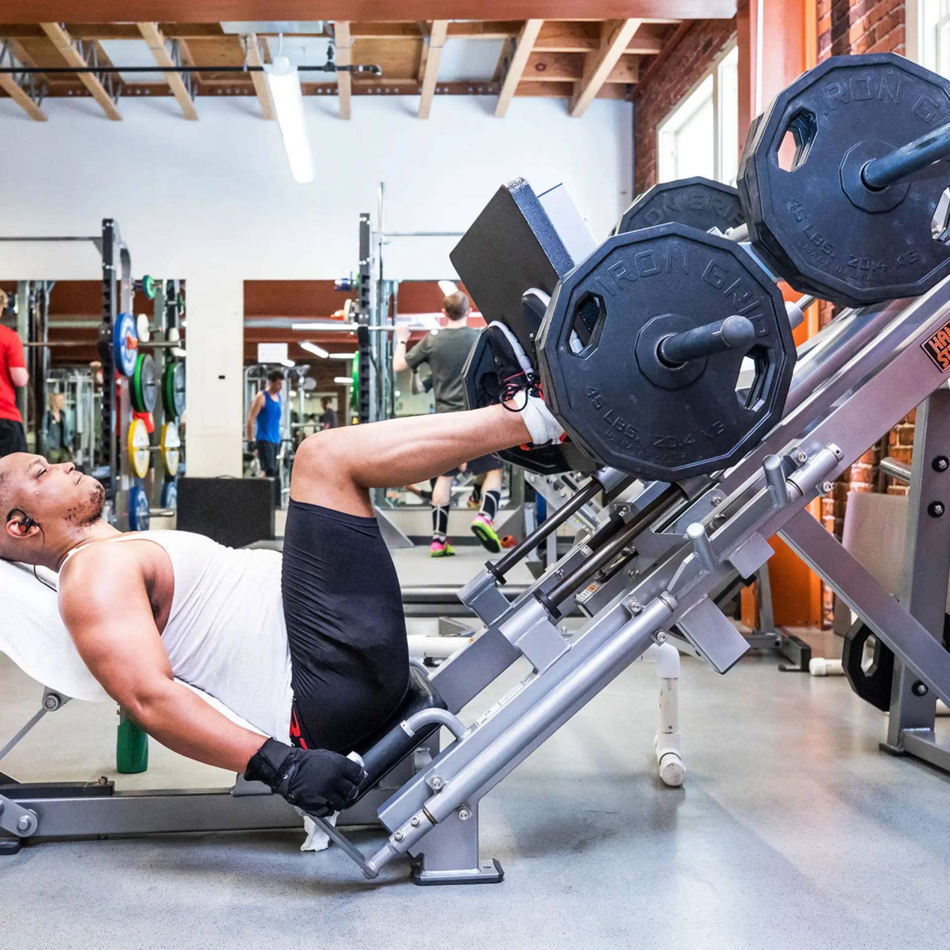 Berkeley YMCA member doing leg weight lifts on machine