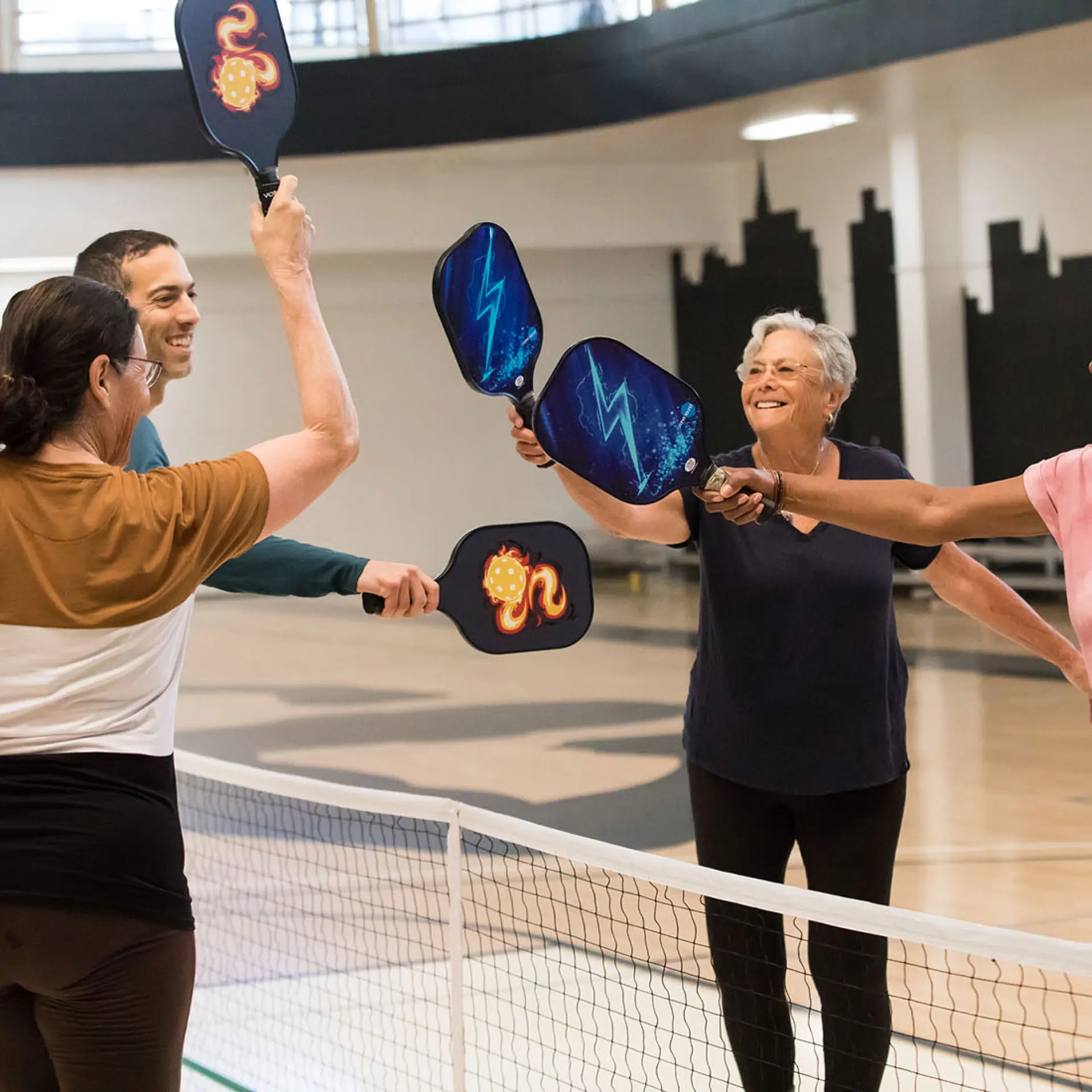 Group of Pickleball players with paddles up at the Oakland YMCA