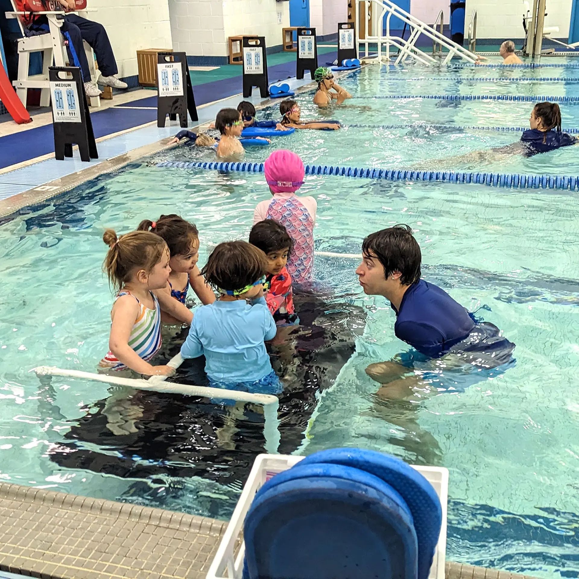 Young students taking swim lessons in the Oakland YMCA lap pool