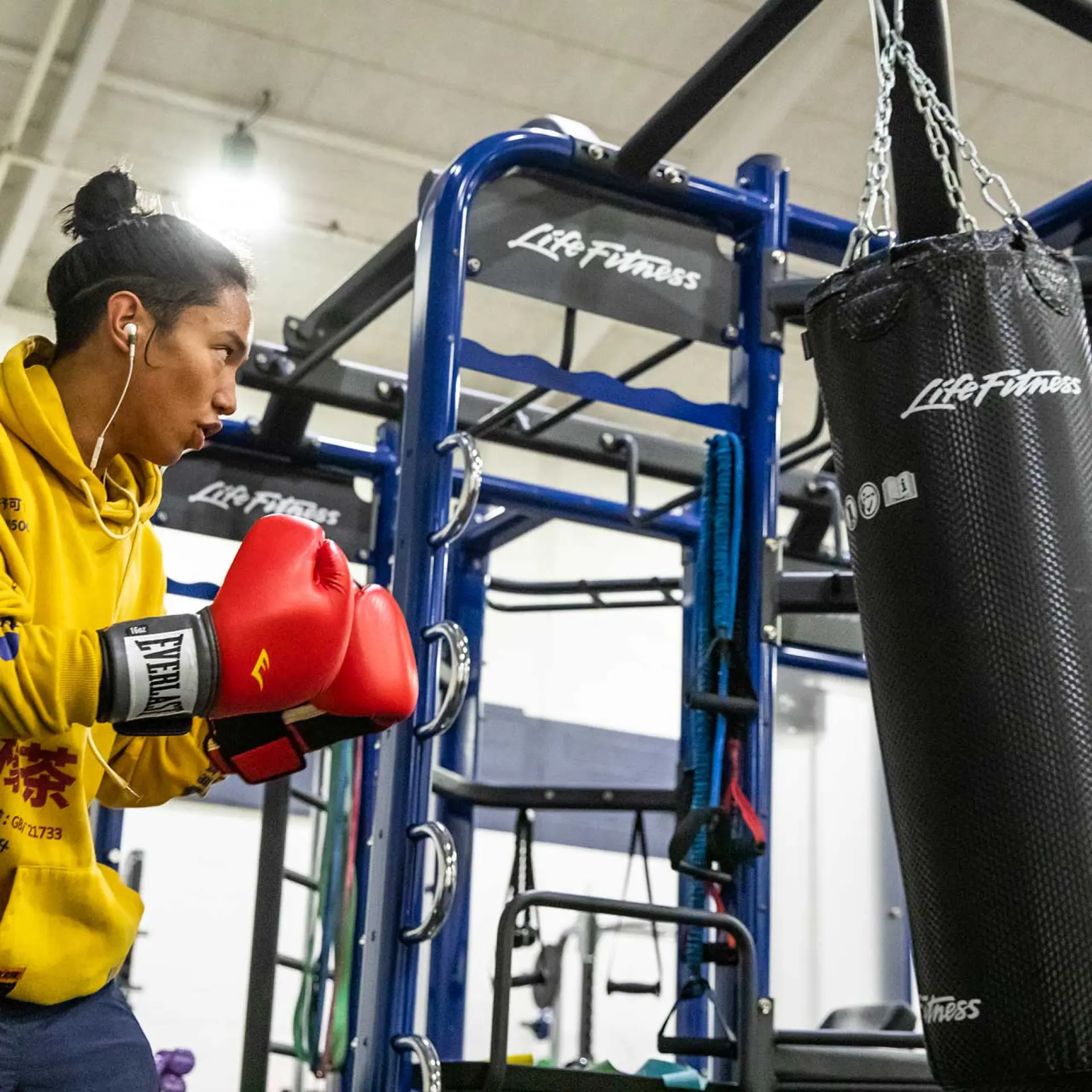 young adult male training with punching bag at the Richmond Parkway YMCA