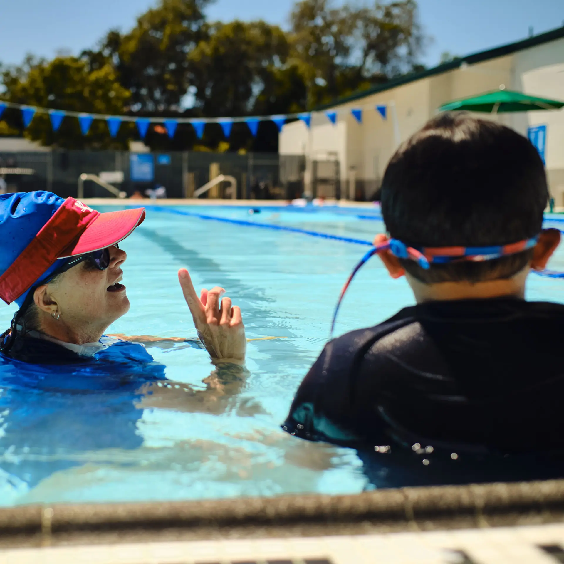 Up close with a young student and swim instructor in the lap pool at the Pleasant Hill YMCA